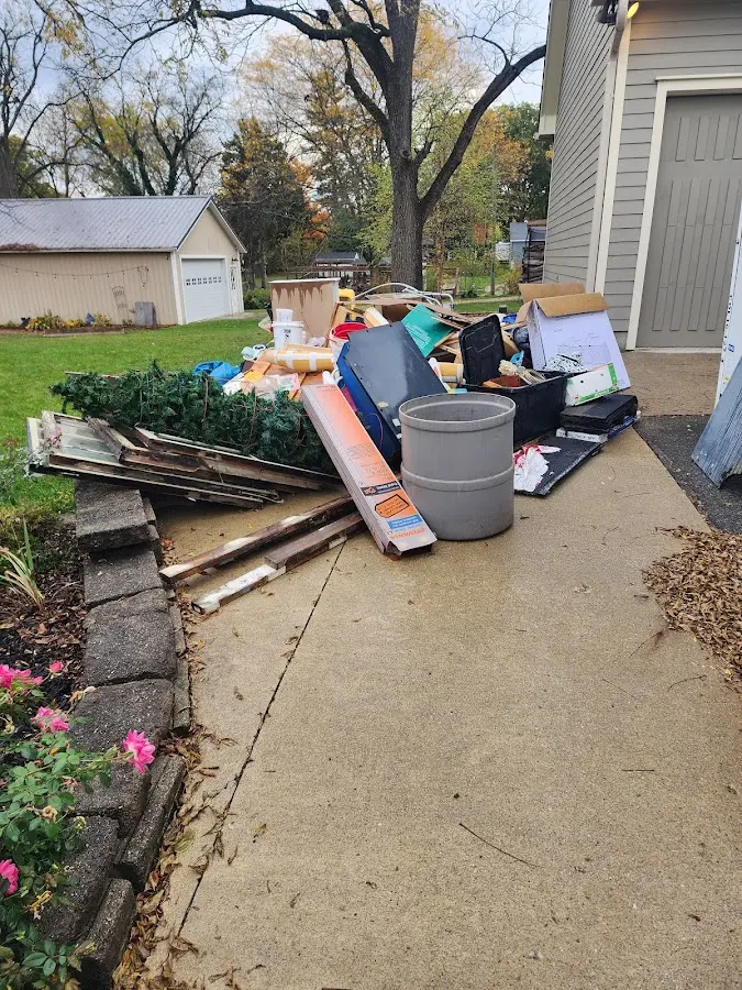 Dumpster being loaded with debris for 12 Yard Dumpster Rental in Greensboro